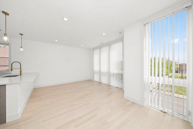 2700 W Jackson Blvd, Chicago, IL 60612 - unfurnished living room with a sink, light wood finished floors, baseboards, and recessed lighting