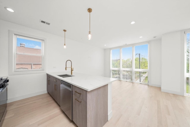 2700 W Jackson Blvd, Chicago, IL 60612 - kitchen featuring a sink, dishwasher, light wood-style flooring, modern cabinets, and a peninsula