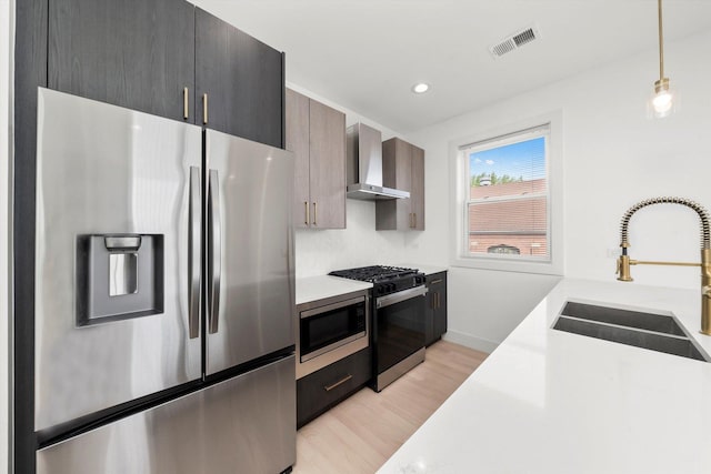 2700 W Jackson Blvd, Chicago, IL 60612 - kitchen with appliances with stainless steel finishes, wall chimney exhaust hood, a sink, light countertops, and recessed lighting