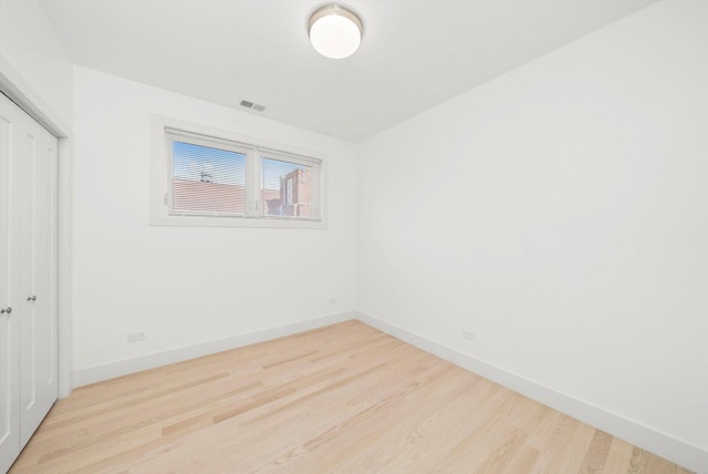 2700 W Jackson Blvd, Chicago, IL 60612 - unfurnished bedroom with baseboards, wood finished floors, and a closet