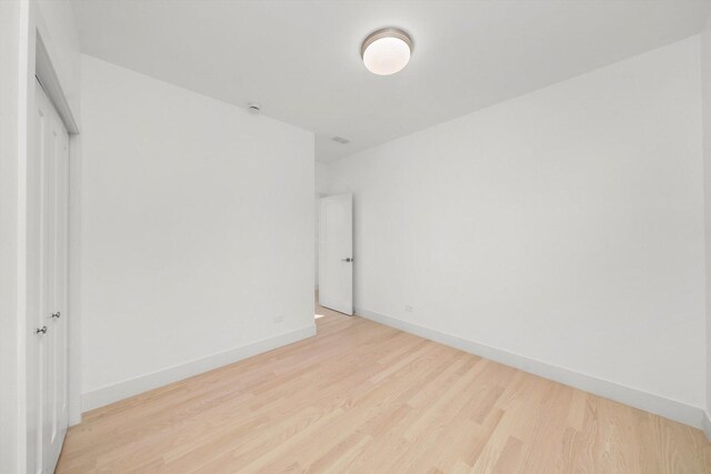 2700 W Jackson Blvd, Chicago, IL 60612 - unfurnished bedroom featuring light wood-type flooring, baseboards, and a closet