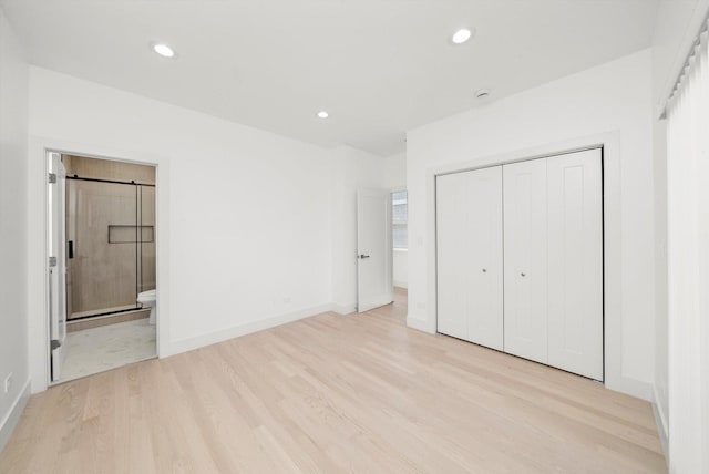 2700 W Jackson Blvd, Chicago, IL 60612 - unfurnished bedroom with light wood-type flooring, a closet, recessed lighting, baseboards, and ensuite bathroom