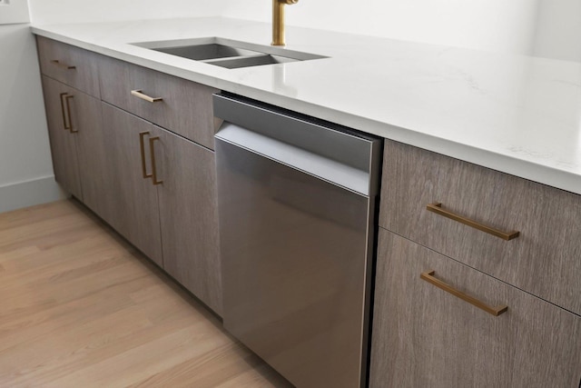 2700 W Jackson Blvd, Chicago, IL 60612 - kitchen with stainless steel dishwasher, a sink, light countertops, light wood-style flooring, and modern cabinets