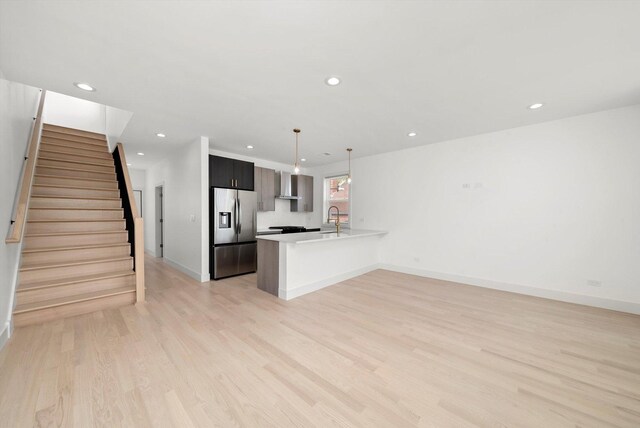 2700 W Jackson Blvd, Chicago, IL 60612 - kitchen featuring stainless steel fridge, wall chimney exhaust hood, a peninsula, a sink, and recessed lighting