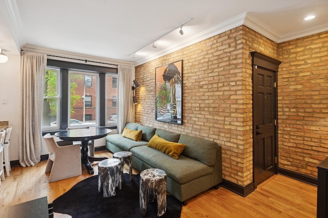 2250 W Argyle St Unit 1, Chicago, IL 60625 - living room featuring brick wall, light wood-style flooring, and rail lighting