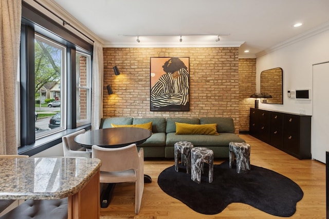2250 W Argyle St Unit 1, Chicago, IL 60625 - living room featuring brick wall, light wood finished floors, and crown molding