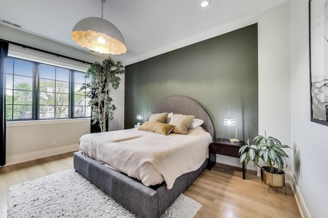 2312 W Hutchinson St, Chicago, IL 60618 - bedroom with light wood-type flooring, baseboards, and recessed lighting