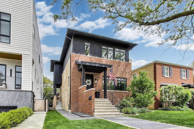2312 W Hutchinson St, Chicago, IL 60618 - contemporary home with brick siding and a front lawn