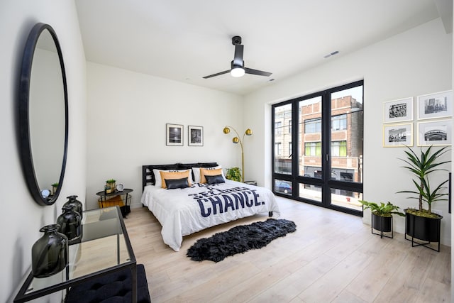 bedroom with access to outside, light wood finished floors, and ceiling fan