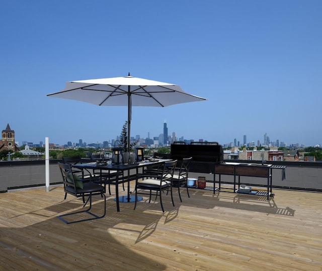 wooden terrace featuring a skyline view