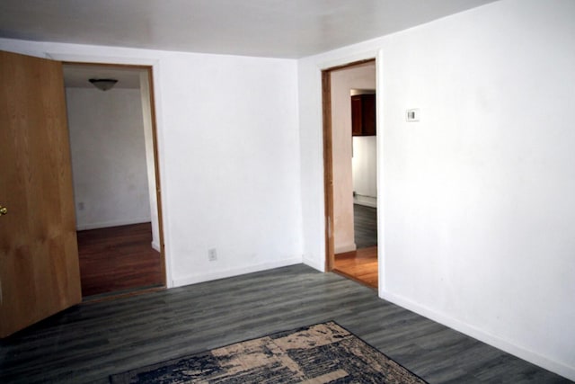 215 S Moore St, South Beloit, IL 61080 - unfurnished room with dark wood-style flooring and baseboards