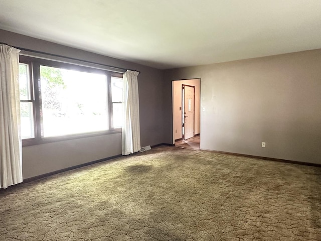 77 Briarcliff Ln, Bourbonnais, IL 60914 - carpeted empty room featuring plenty of natural light and baseboards