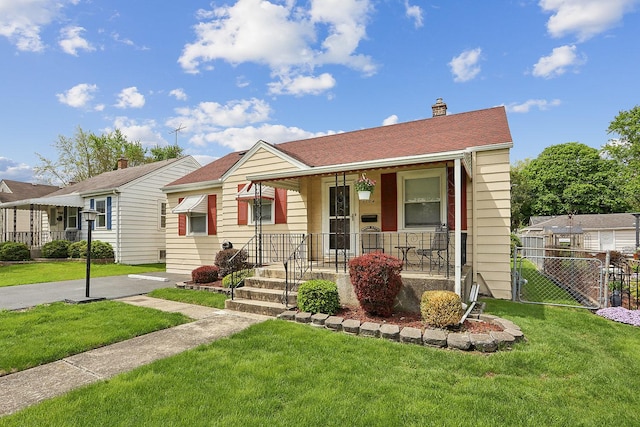 bungalow featuring a porch and a chimney