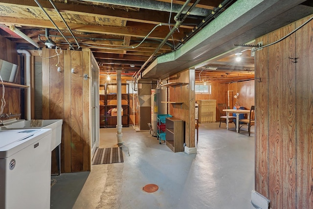 basement featuring wooden walls and washer / clothes dryer