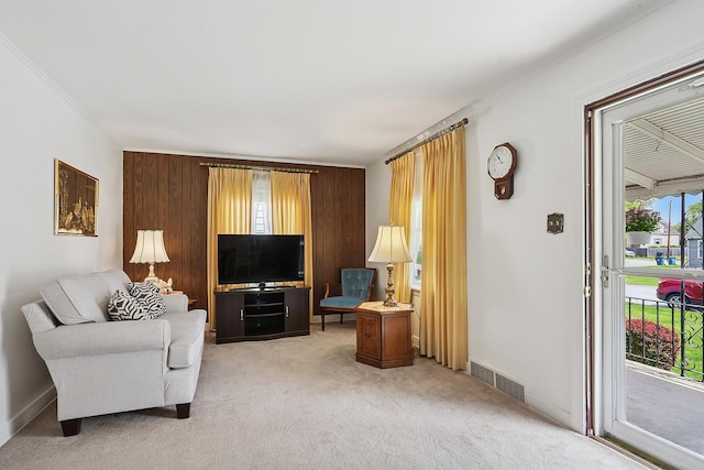 living room featuring light carpet and ornamental molding