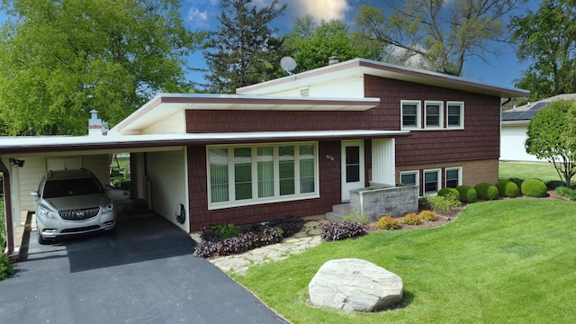 406 E Fine St, Ashkum, IL 60911 - tri-level home featuring a front lawn, driveway, and a carport