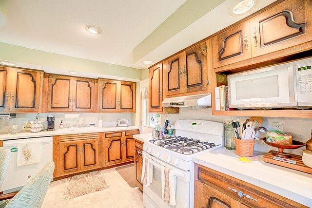 406 E Fine St, Ashkum, IL 60911 - kitchen featuring under cabinet range hood, white appliances, brown cabinets, light countertops, and recessed lighting