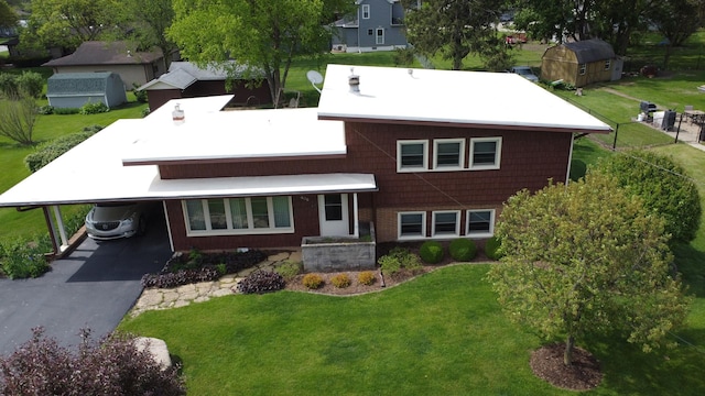 406 E Fine St, Ashkum, IL 60911 - view of front facade featuring a front lawn, a carport, and driveway