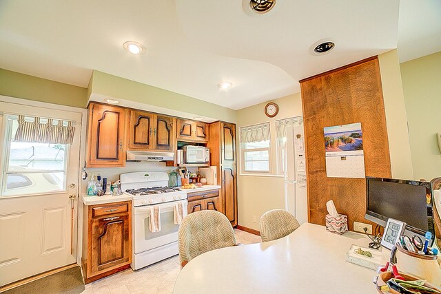 406 E Fine St, Ashkum, IL 60911 - kitchen with white appliances, under cabinet range hood, brown cabinets, light countertops, and recessed lighting