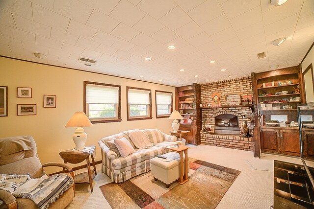 406 E Fine St, Ashkum, IL 60911 - carpeted living room featuring a brick fireplace, built in shelves, and recessed lighting