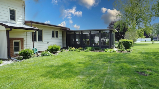 406 E Fine St, Ashkum, IL 60911 - rear view of property with a sunroom and a lawn
