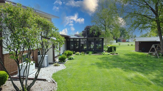 406 E Fine St, Ashkum, IL 60911 - view of grassy yard featuring a sunroom
