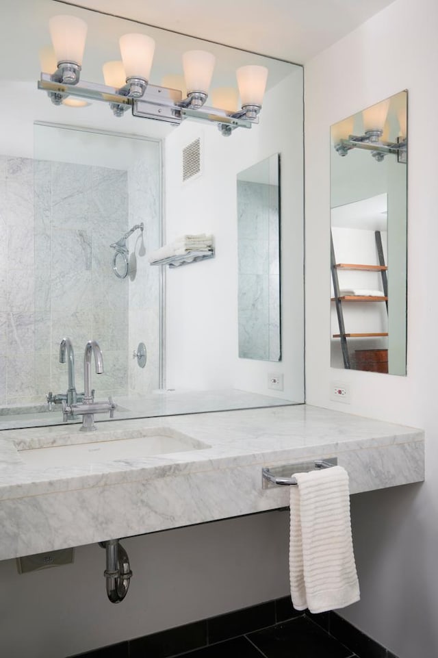 bathroom with tile patterned floors and vanity