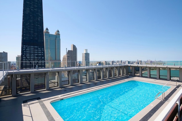 community pool featuring a skyline view and a patio