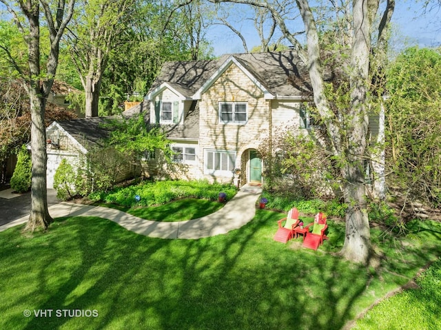 630 Juniper Rd, Glenview, IL 60025 - view of front facade featuring stone siding, a front yard, and a chimney