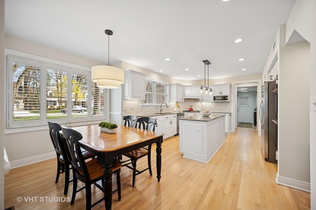 630 Juniper Rd, Glenview, IL 60025 - dining area with light wood finished floors, baseboards, and recessed lighting