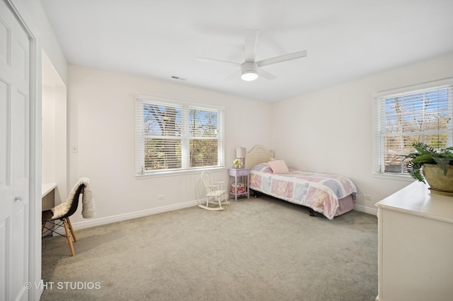 630 Juniper Rd, Glenview, IL 60025 - carpeted bedroom featuring multiple windows, baseboards, and a ceiling fan