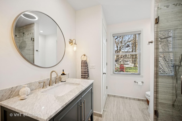 630 Juniper Rd, Glenview, IL 60025 - bathroom with vanity, baseboards, a tile shower, and toilet