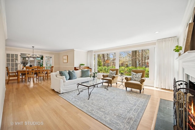 630 Juniper Rd, Glenview, IL 60025 - living area with a fireplace with flush hearth, light wood-type flooring, a chandelier, and crown molding
