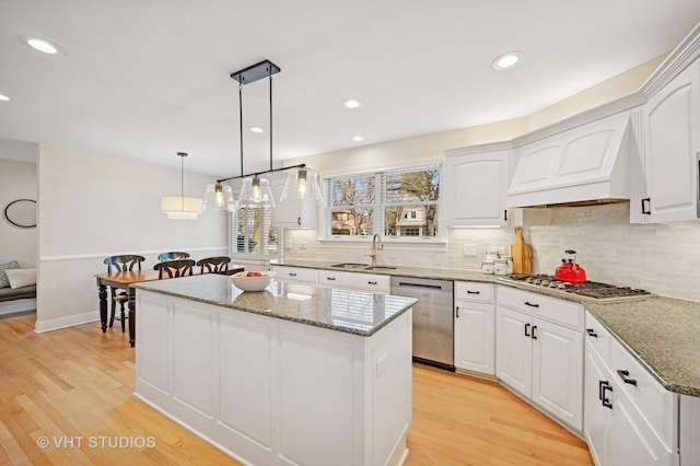 630 Juniper Rd, Glenview, IL 60025 - kitchen with appliances with stainless steel finishes, a kitchen island, a sink, custom exhaust hood, and light stone countertops