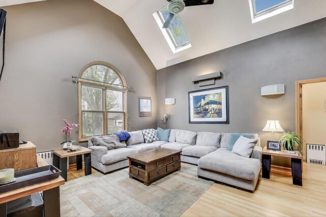35 Keystone Ave, River Forest, IL 60305 - living area featuring high vaulted ceiling, a skylight, wood finished floors, and radiator