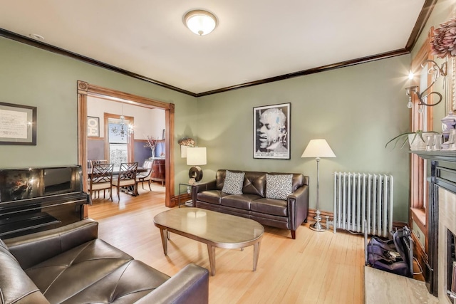 35 Keystone Ave, River Forest, IL 60305 - living area with radiator heating unit, a fireplace with flush hearth, wood finished floors, ornamental molding, and baseboards