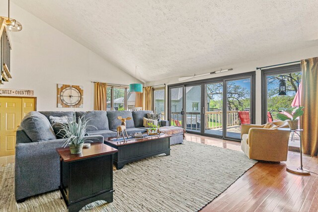 10632 Ventura Blvd, Machesney Park, IL 61115 - living area featuring a textured ceiling, hardwood / wood-style flooring, plenty of natural light, and vaulted ceiling