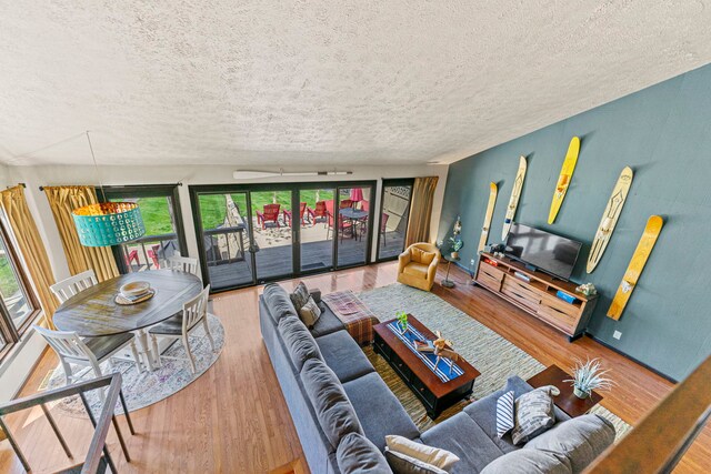 10632 Ventura Blvd, Machesney Park, IL 61115 - living room featuring a textured ceiling and wood finished floors