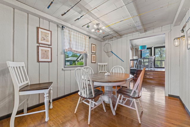 10632 Ventura Blvd, Machesney Park, IL 61115 - dining space featuring wood finished floors, baseboards, and a chandelier