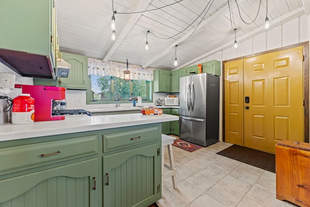 10632 Ventura Blvd, Machesney Park, IL 61115 - kitchen with green cabinetry, freestanding refrigerator, a sink, and a peninsula