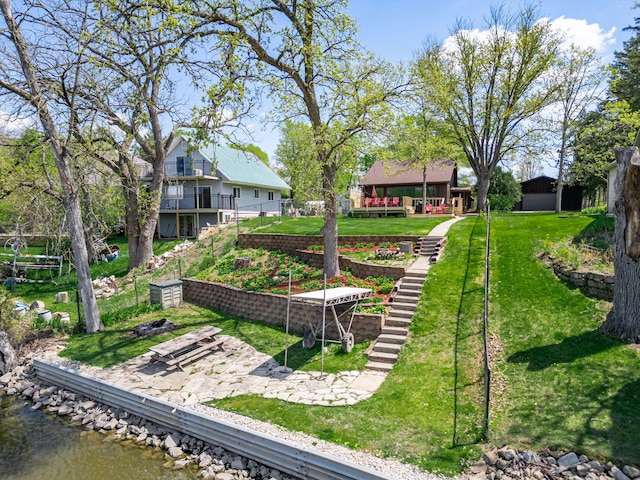 10632 Ventura Blvd, Machesney Park, IL 61115 - view of home's community with a water view, a lawn, and a garden