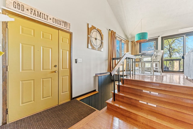 10632 Ventura Blvd, Machesney Park, IL 61115 - foyer entrance featuring lofted ceiling, wood finished floors, and stairs