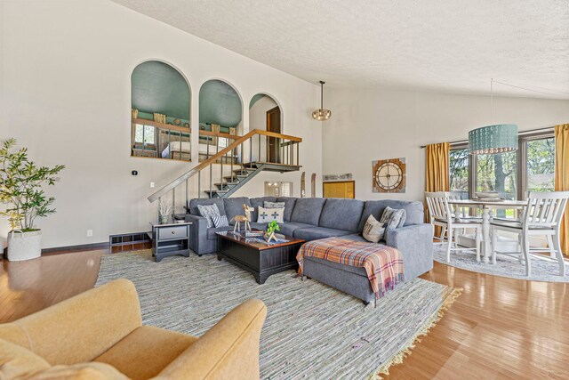 10632 Ventura Blvd, Machesney Park, IL 61115 - living area with a textured ceiling, stairway, wood finished floors, lofted ceiling, and baseboards