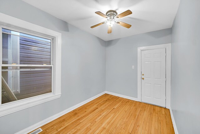 7316 S Woodlawn Ave, Chicago, IL 60619 - empty room with baseboards, light wood-style floors, and a ceiling fan