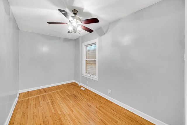 7316 S Woodlawn Ave, Chicago, IL 60619 - unfurnished room with baseboards, ceiling fan, and light wood-style flooring