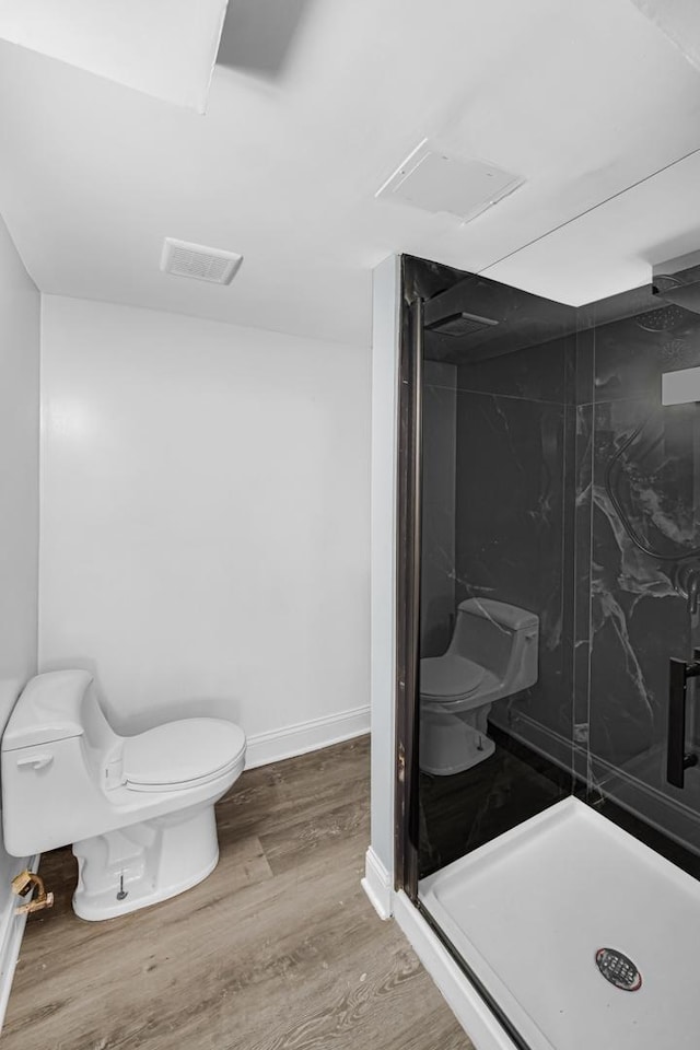 7316 S Woodlawn Ave, Chicago, IL 60619 - bathroom featuring toilet, a shower stall, wood finished floors, and baseboards