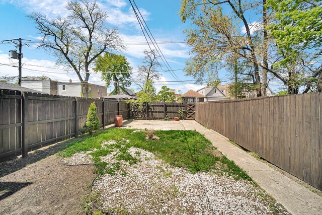 7316 S Woodlawn Ave, Chicago, IL 60619 - fenced backyard with a patio area