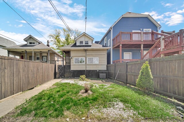 7316 S Woodlawn Ave, Chicago, IL 60619 - rear view of house featuring a fenced backyard, cooling unit, and a gate