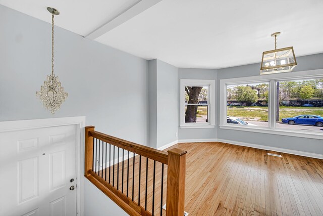 7316 S Woodlawn Ave, Chicago, IL 60619 - entrance foyer with a chandelier, hardwood / wood-style floors, and baseboards