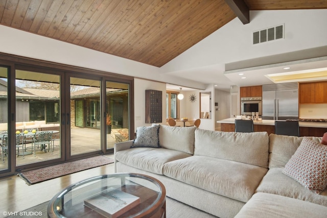 living area featuring light wood-type flooring, beam ceiling, high vaulted ceiling, and recessed lighting
